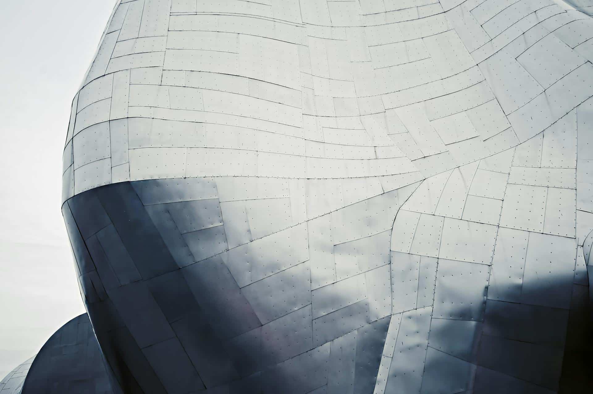 Close-up of modern geometric steel architecture with a sleek metal texture and abstract design.